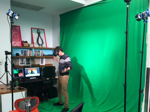 Student work on VR video game in front of green screen