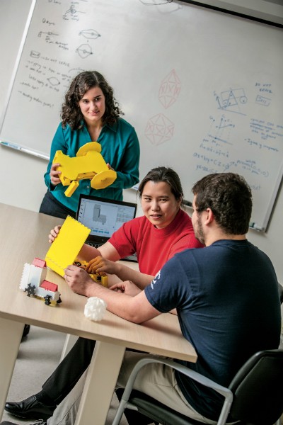 Sung discusses robogami with doctoral student Jessica McWilliams and MEAM senior Andres Zambrano