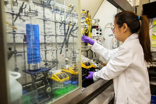 Engineer in lab coat works in research lab