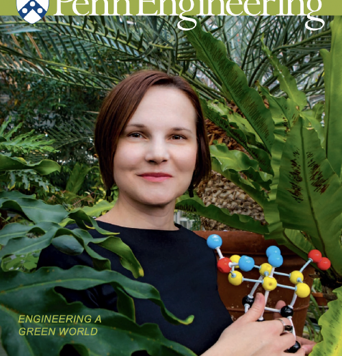Aleksandra Vojvodic on the cover of the Spring 2019 edition of Penn Engineering Magazine, holding a model of a molecule while standing in a greenhouse