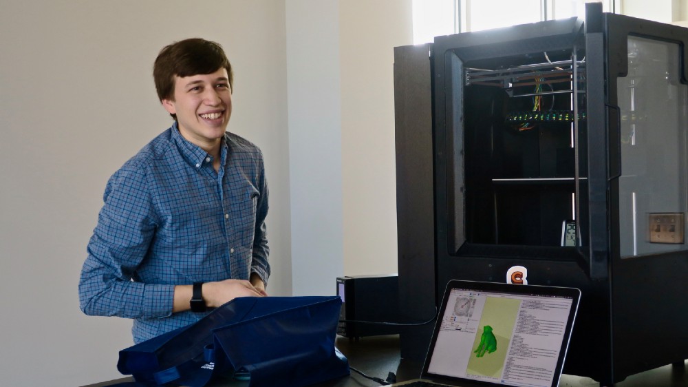 Evan Weinstein poses with his Cocoa Press chocolate printer. 
