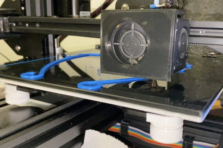 3D printer printing out face shield mounts for PPE