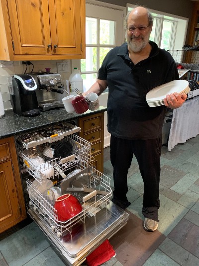 Stuart Diamond loads a dishwasher