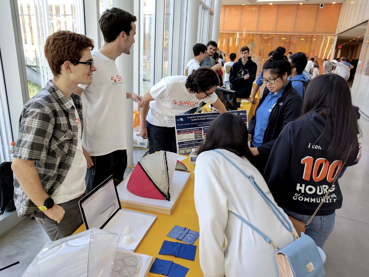 Students show off model tents with to visitors at the Singh Center.