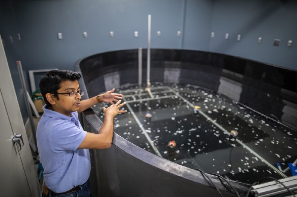 Man stands in front of research lab pool