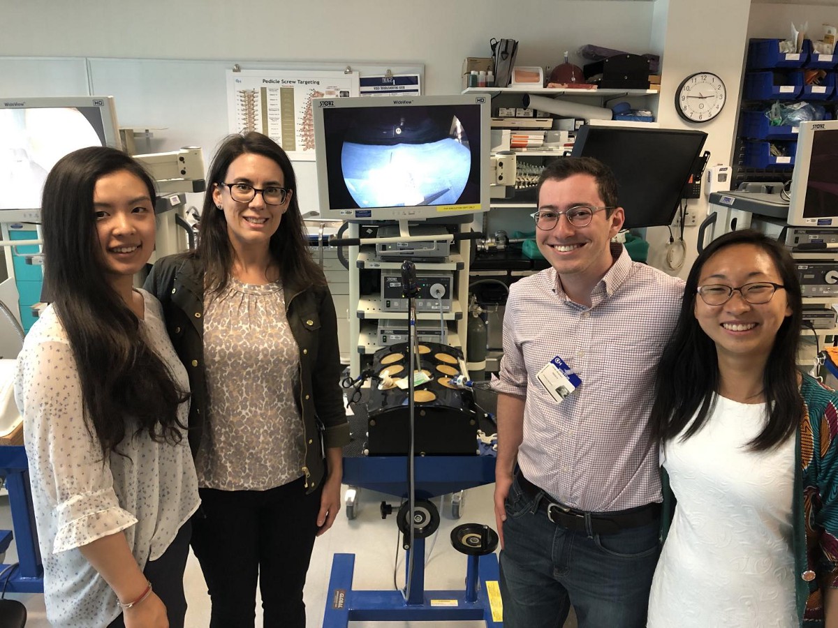 Headway Team poses in lab setting. Team members (left to right): Alex Wan, Laura Ceccaci, Jonah Arnheim, Julia Lin.