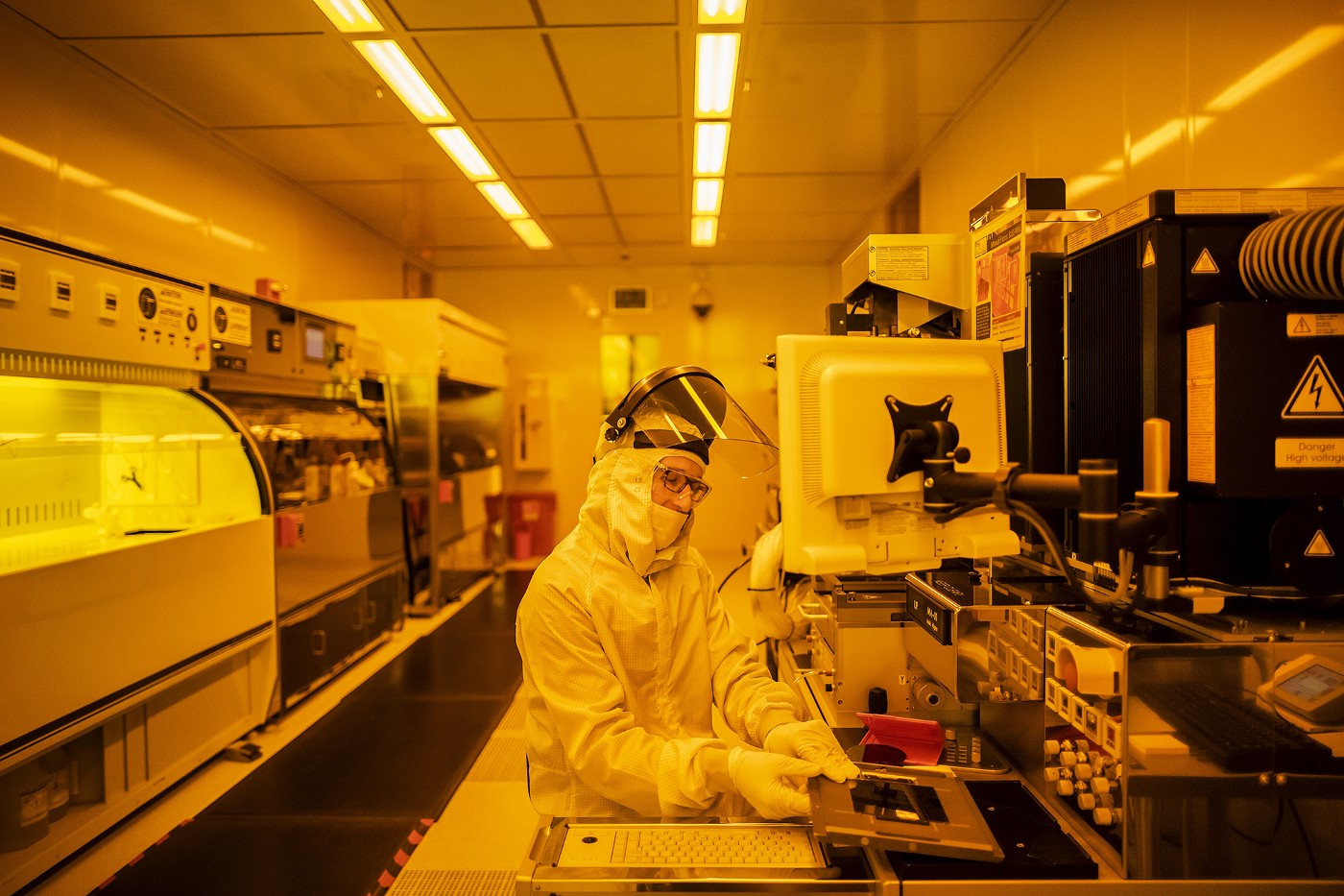 Researcher in full-body PPE conducts experiment in nanotechnology lab