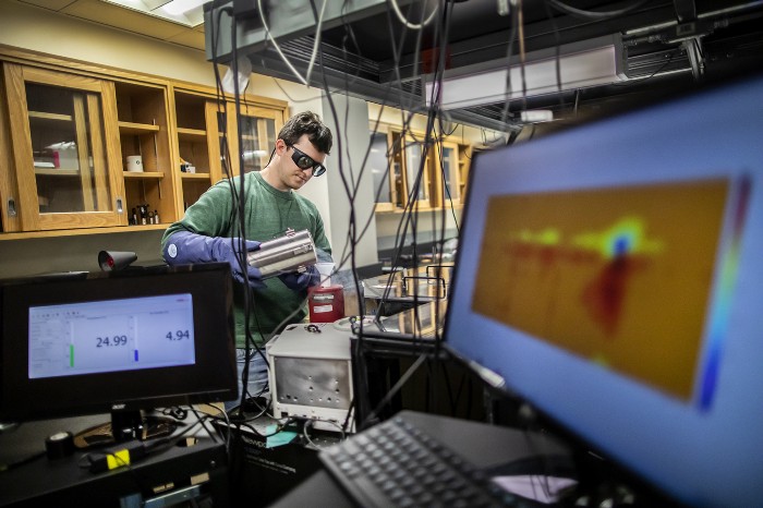 Ph.D. graduate Stephen Meloni in the physical chemistry lab of Jessica Anna