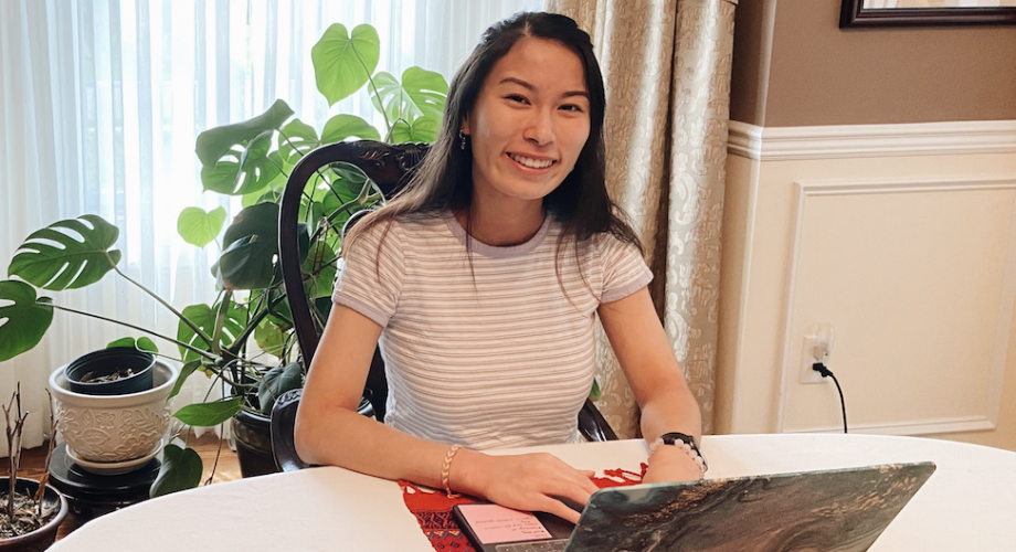 Anna Jiang working at a laptop.