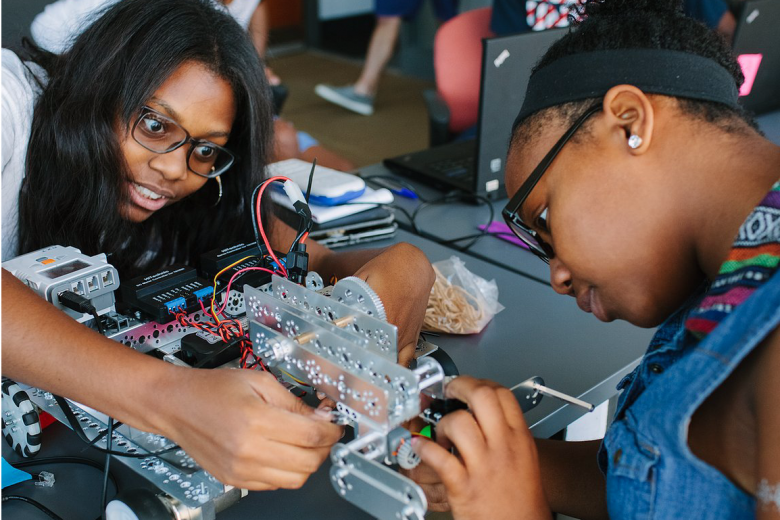 Blended Learning Initiative students working on a robot