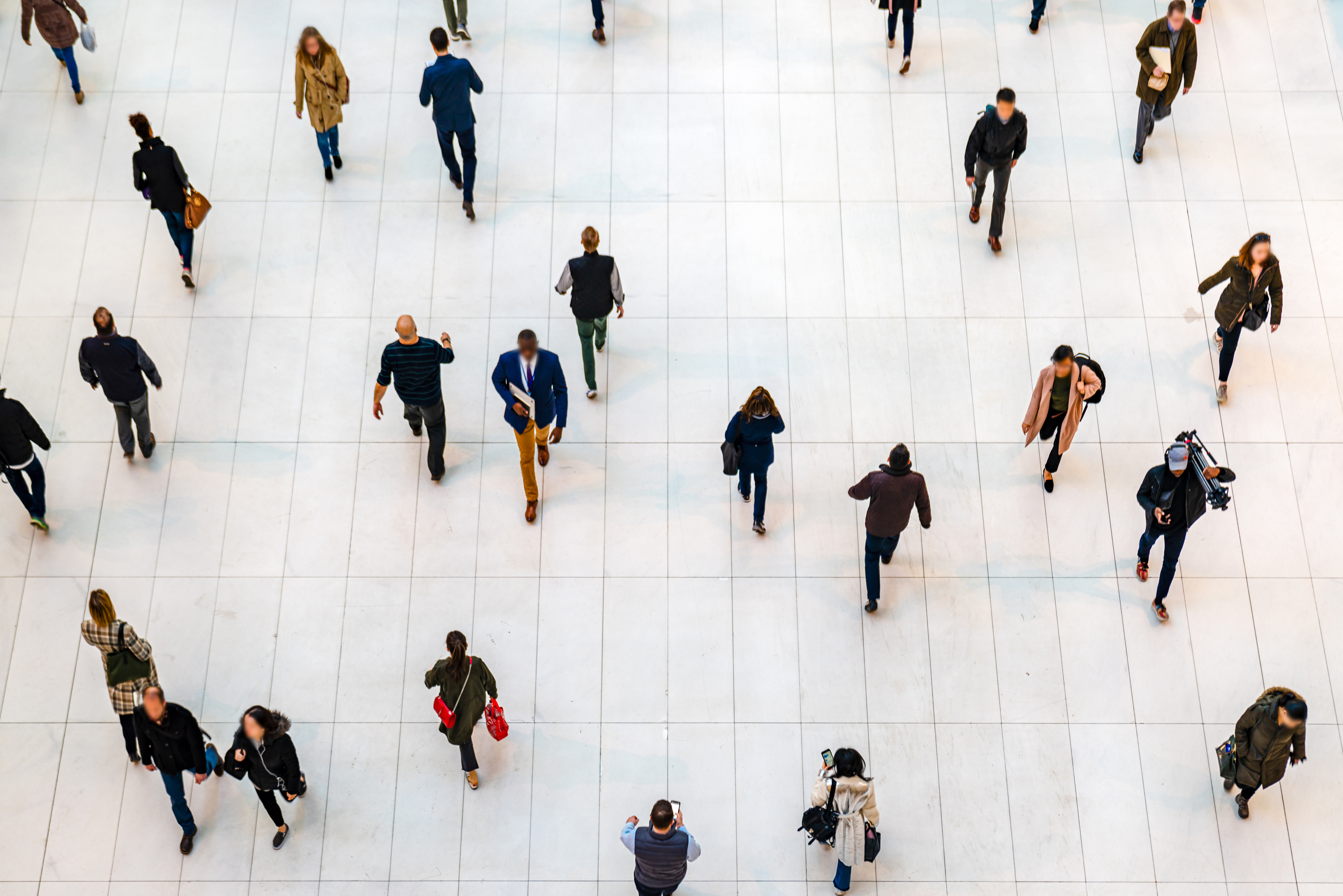 An overhead shot of people walking in a crowd.