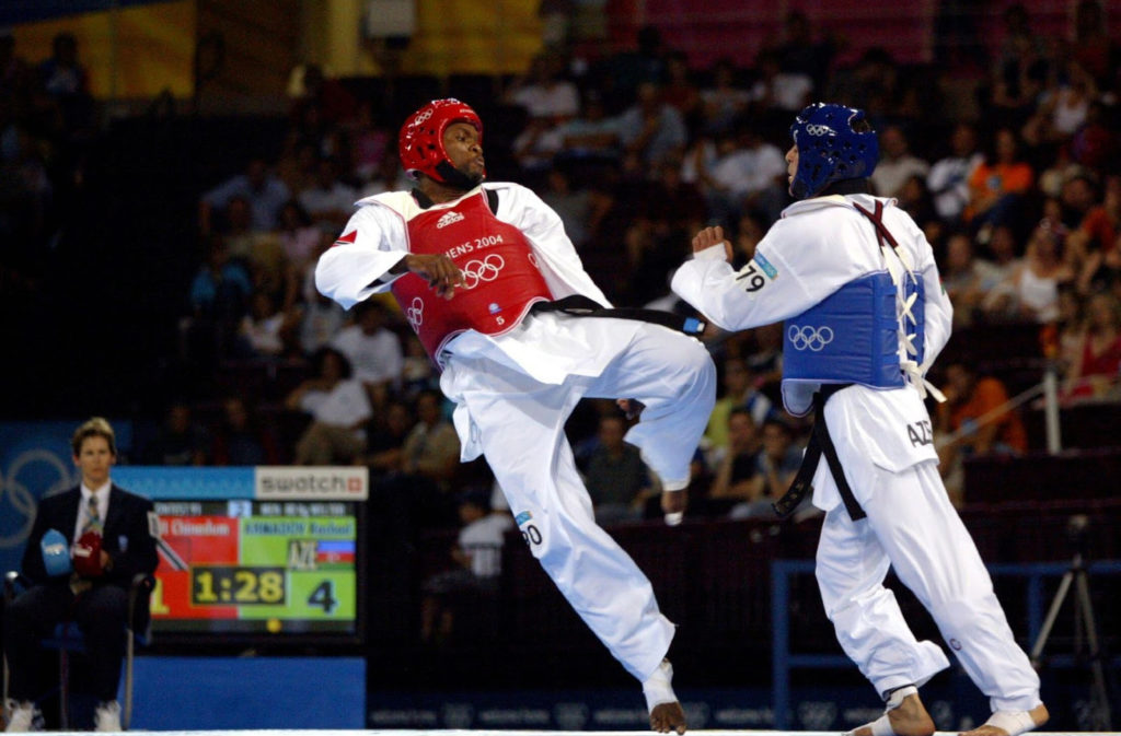 Chinedum Osuji delivers a kick in a taekwondo match at the 2004 Olympic Games