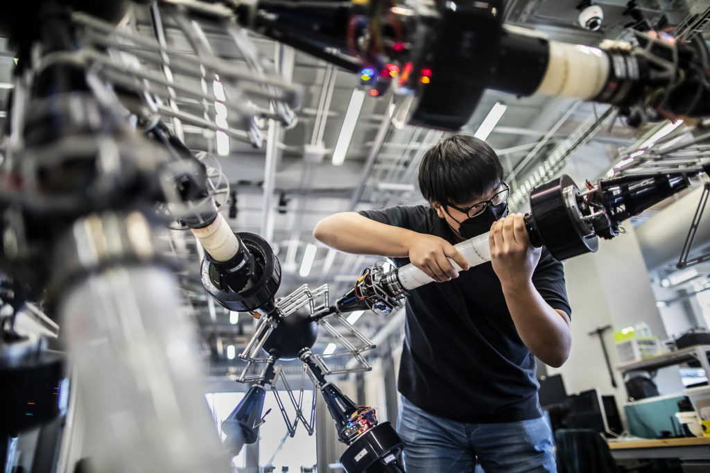 A student works on a robotic arm at PERCH