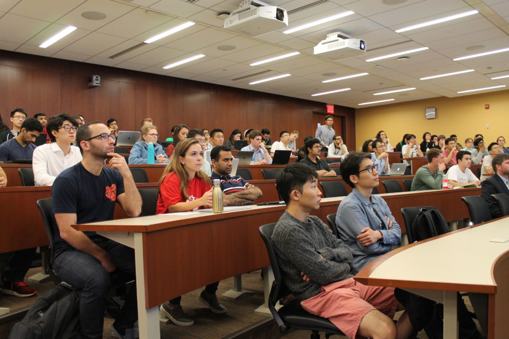 Students in lecture hall listening to the rules of the Y prize.
