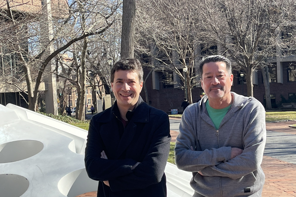 Aaron Roth (left) and Michael Kearns (right) stand on the Penn campus on a sunny winter day. 