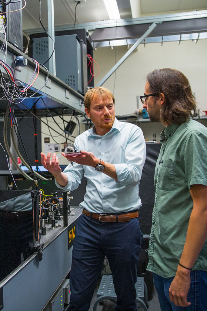 Lee Bassett with student in lab