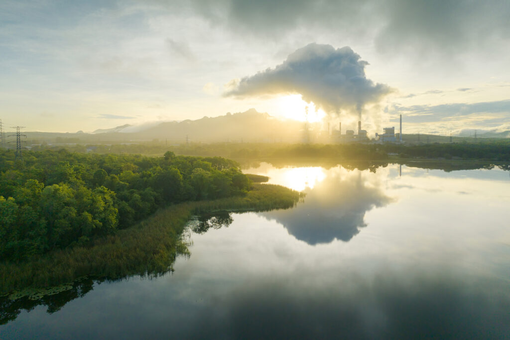 Aerial view coal power plant station in the morning mist, the morning sunrises. coal power plant and environment concept. Coal and steam. Mae Moh, Lampang, Thailand.