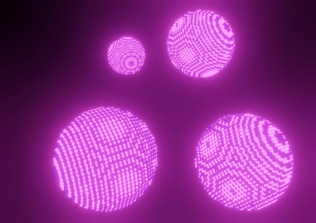 Artist's impression of nanocrystals. Four pink ball like structures floating in the air.
