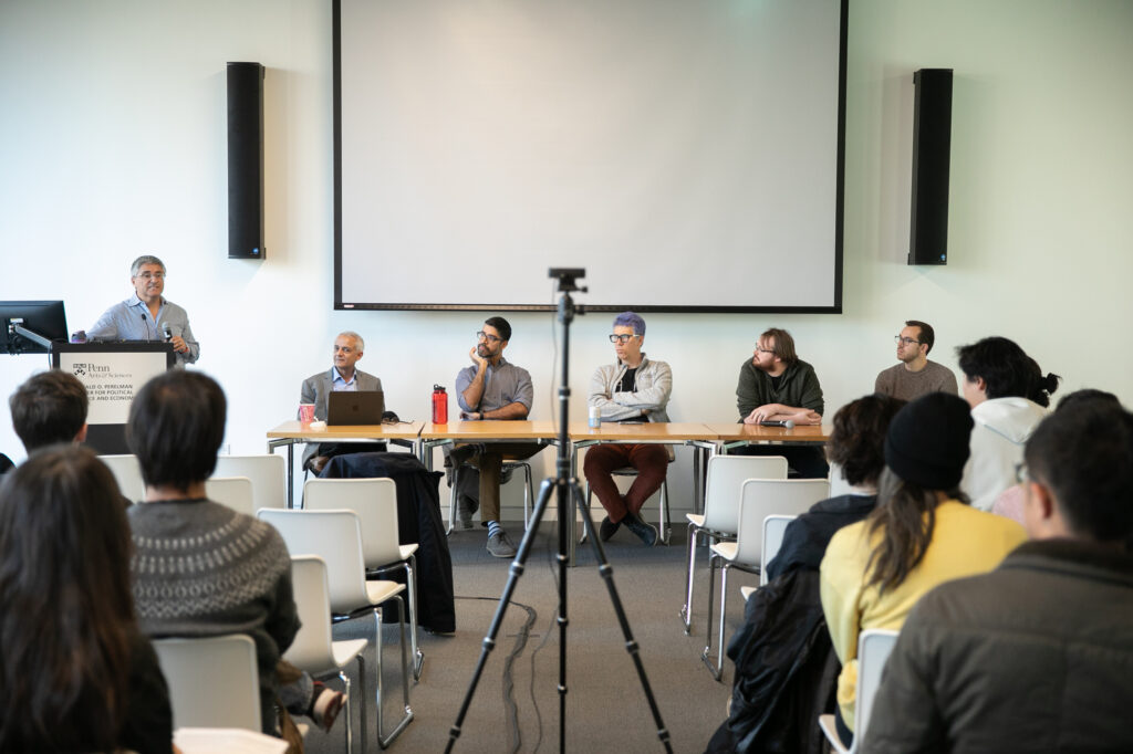 René Vidal, at the podium, introduces the event “ChatGPT turns one: How is generative AI reshaping science?” Bhuvnesh Jain, left at the table, moderated the discussion with Sudeep Bhatia, Konrad Kording, Andrew Zahrt, and Nick Pangakis.