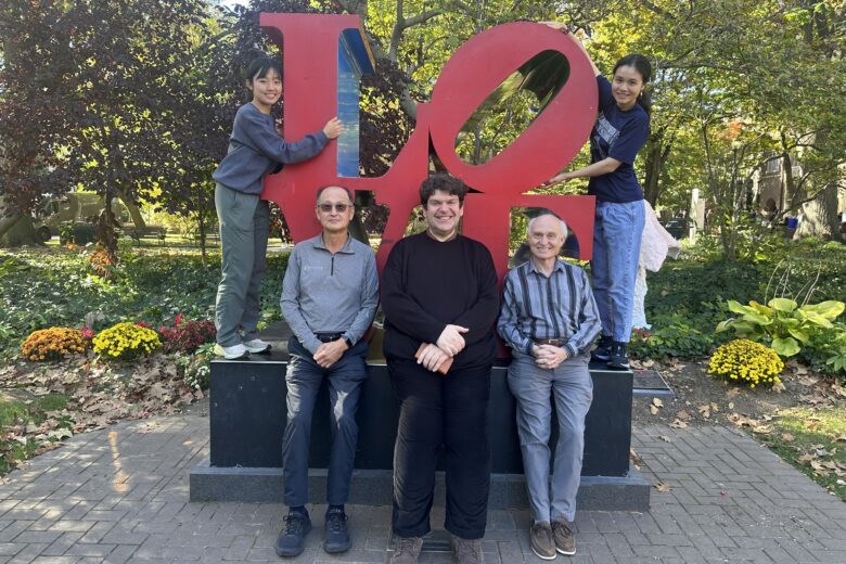 Students and Professors in front of the LOVE statue on Penn's campus. From left to right top - Ahhyun Yuh (hugging the "L") and Xiayan Ji (hugging the "O") sitting - Insup Lee, George Demiris, Oleg Sokolsky