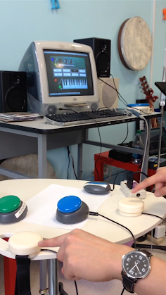 Lyle Brunhofer, off-camera, works on accessible switches for students with cerebral palsy as part of Senior Design in 2014.