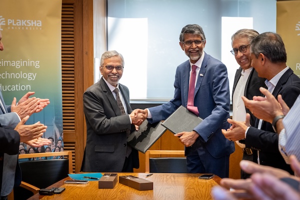 Rudra Pratap (left) and VIjay Kumar (right) shake hands at the signing ceremony