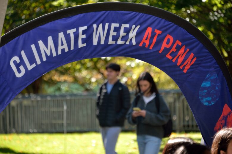 Picture of students walking near College Hall on campus for Climate Week.