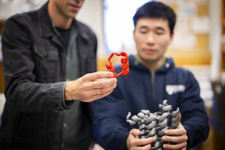 Researcher César de la Fuente, who recently developed a state-of-the-art AI model that can predict whether a given amino acid sequence will have antibiotic properties is pictured showing a student his latest model.