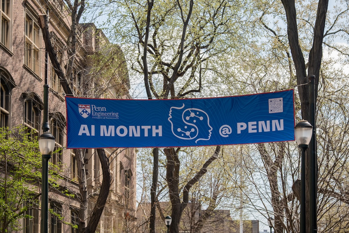 A banner reading "AI Month @ Penn" hangs over Smith Walk.