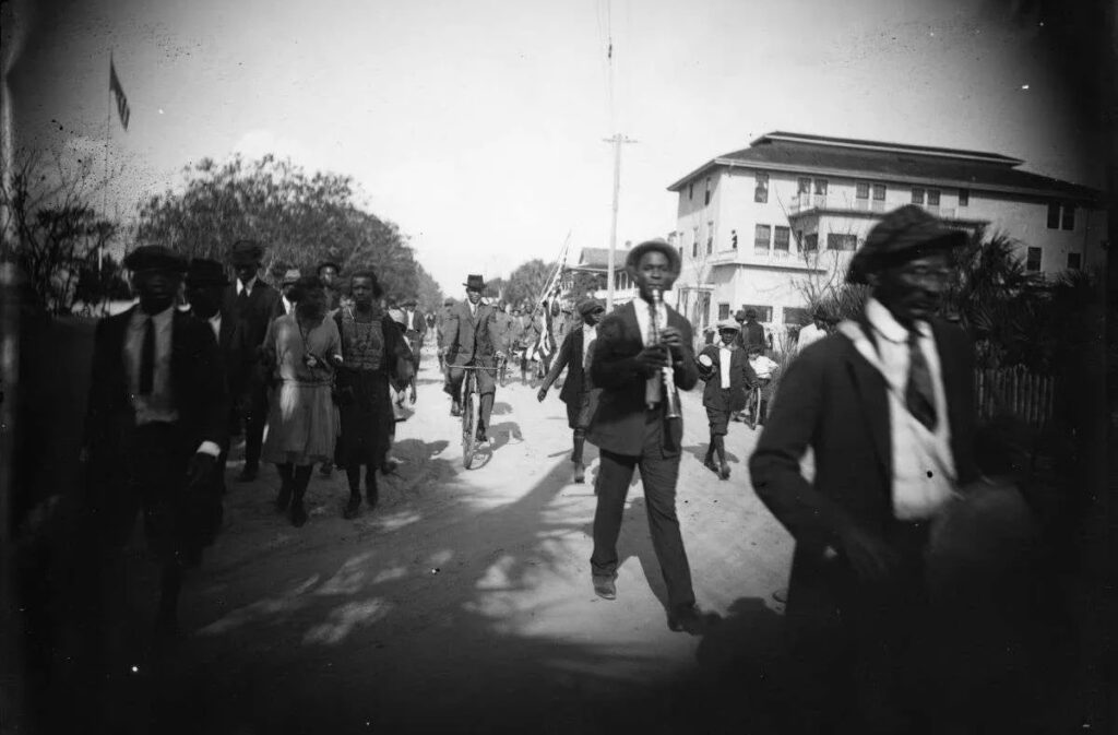 A picture of men and women walking in a parade in 1922 in St. Augustine, Florida.