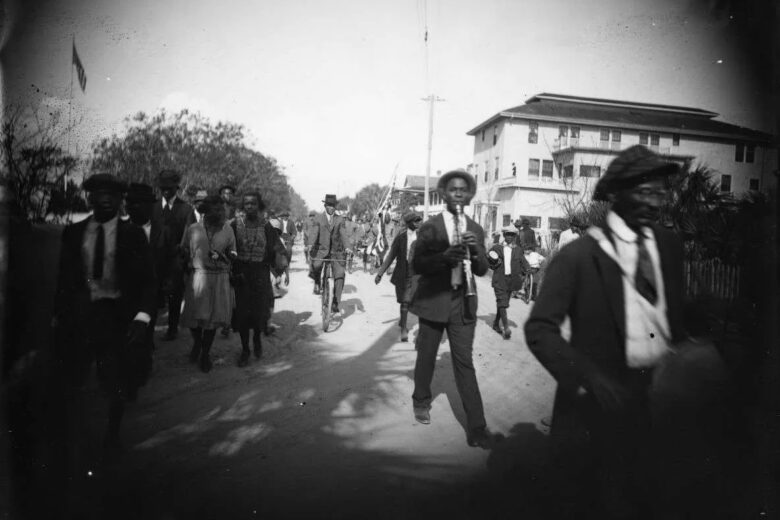 A picture of men and women walking in a parade in 1922 in St. Augustine, Florida.