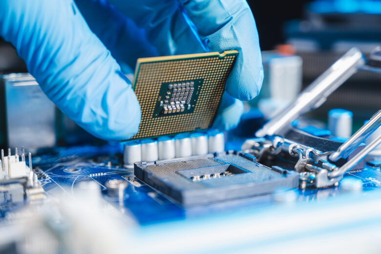 Picture of two hands with a computer chip