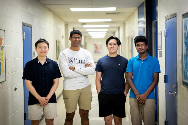 Picture of four male students in a hallway - Nihar Ballamudi (second from left) and Chinmay Govind (far right) participated in the Penn Undergraduate Research Mentoring Program this summer, using machine learning models to monitor whale sounds, locations, and population sizes. Mason Liu (far left) and Justin Duong (second from right) are working on related projects about locating and censusing whales.